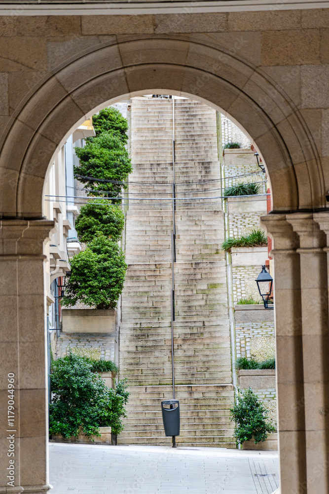 Beautiful Arch leading to staircase on main square Praza de Maria Pita in Coruna, Galicia, Spain