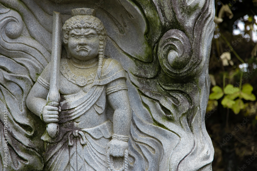 A religious stone statue of Acala at Japanese buddhism temple A religious stone statue of Acala at Japanese buddhism temple