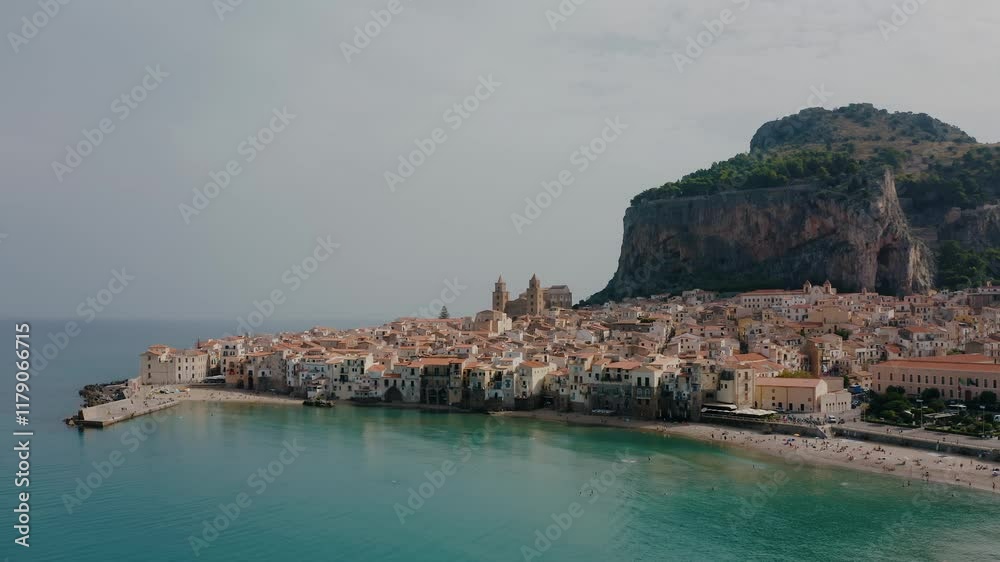 Aerial drone shot of beautiful historic town by the beach. Cefalu sea bay in Sicily. Ancient Italian town. Aerial drone shot of beautiful historic town by the beach. Cefalu sea bay in Sicily. Ancient Italian town.
