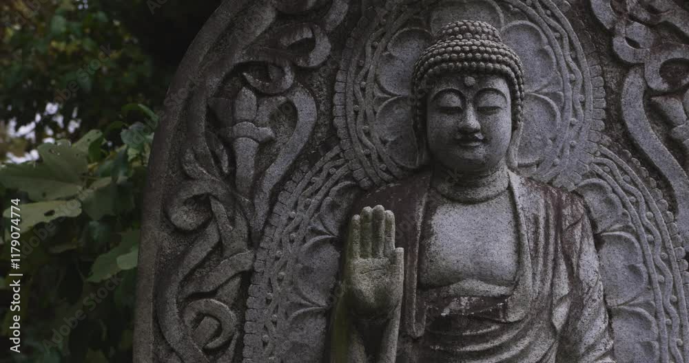A religious stone statue of Medicine Buddha at Japanese buddhism temple A religious stone statue of Medicine Buddha at Japanese buddhism temple