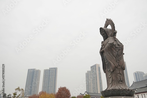 Statue with Skyscrapers in the Background photo