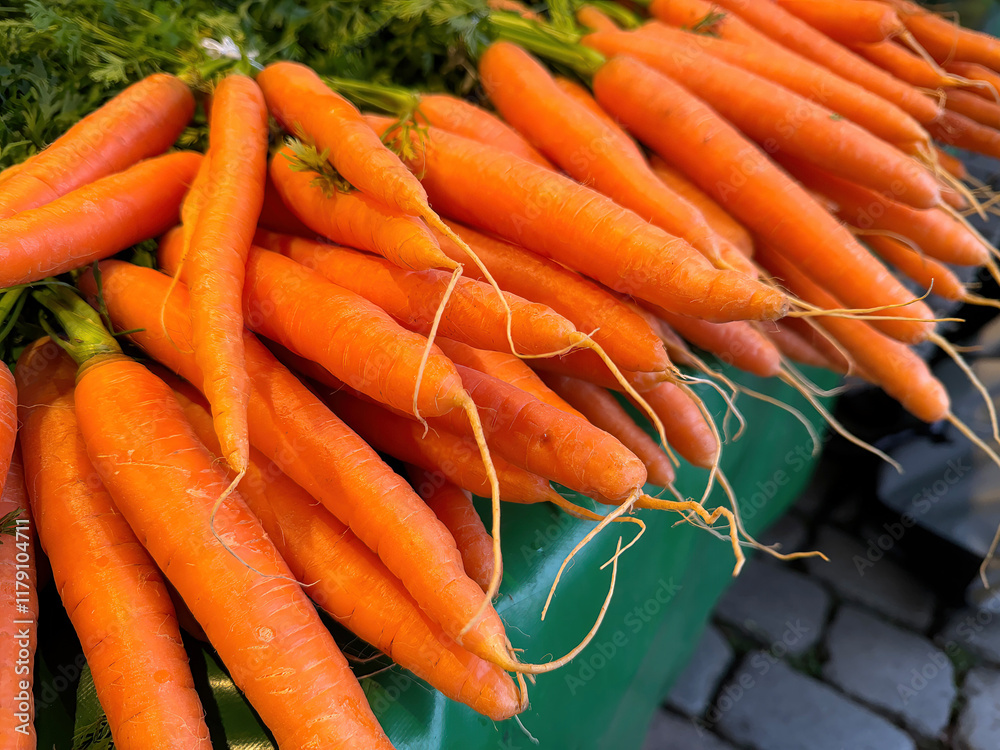 Bunch of bright orange carrots vegetables at a market stall Bunch of bright orange carrots vegetables at a market stall