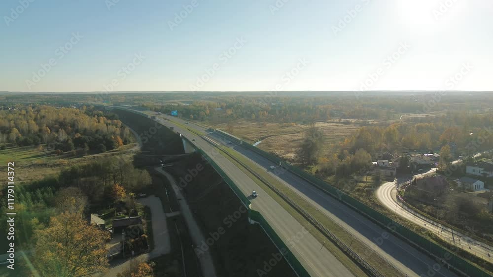 Modern freeway with vehicles and noise barriers