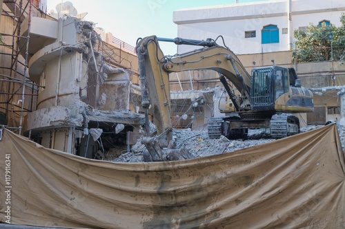 Old low-rise building under demolition in Dubai, showcasing urban redevelopment and renewal processes of city property landscape in the city. 