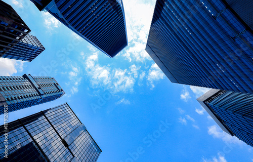 Worm's eye view of a city skyline with modern business office buildings, One Bangkok department store, and skyscrapers in Bangkok's business district capital of Thailand