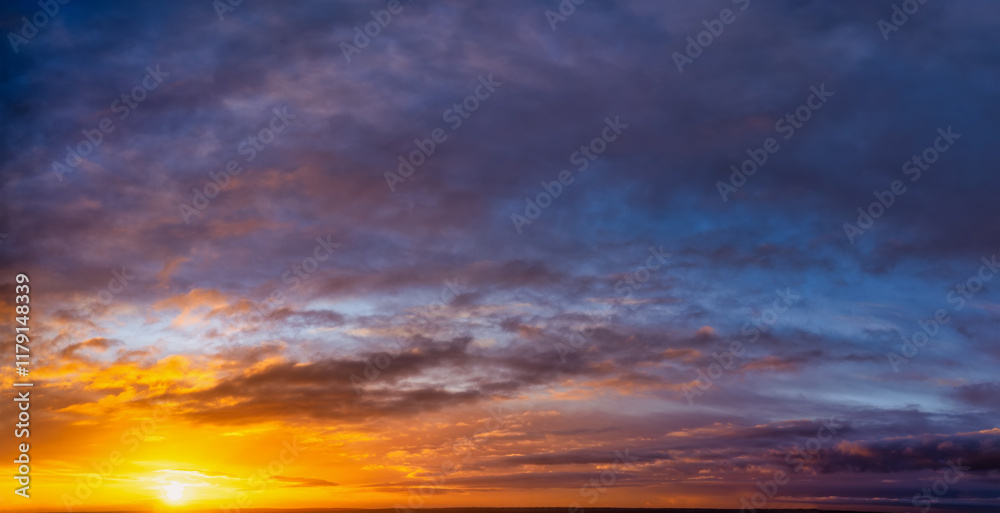 A vibrant sunrise sky with orange and pink colors as a background or texture A vibrant sunrise sky with orange and pink colors as a background or texture