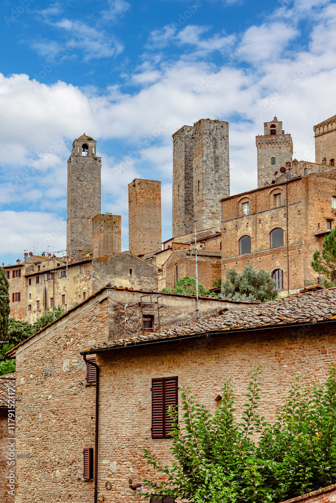 The medieval towers and architecture of San Gimignano in Tuscany under a bright blue sky