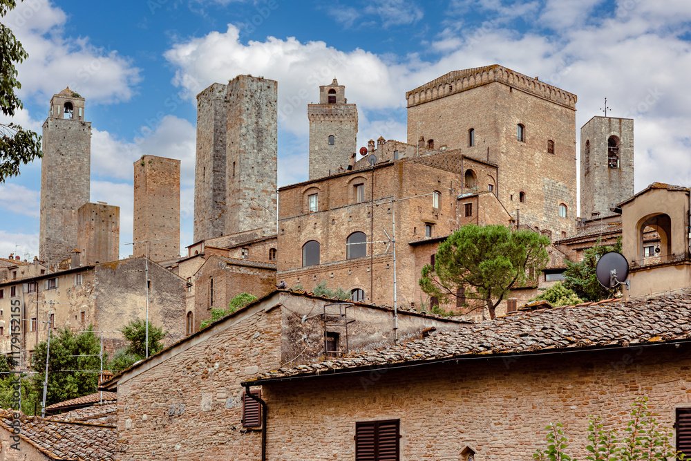 The medieval towers and architecture of San Gimignano in Tuscany under a bright blue sky