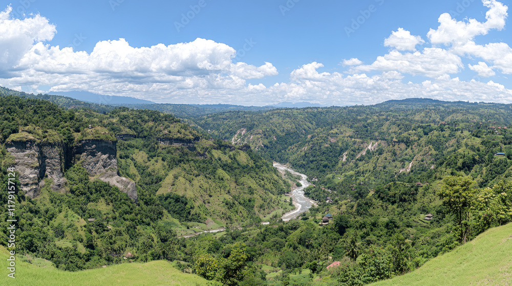 Fototapeta premium Lush valley with river, mountains, and clouds. Scenic view. Possible use Nature background.