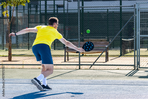 Pickleball player performing a backhand during training on a sunny day photo