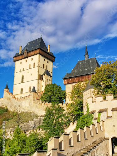 A different perspective. A view of the medieval castle Karlstejn. The walls and forests around. Sunny day. photo