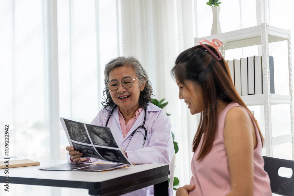 Senior female Doctor Discussing Ultrasound Results with Pregnant Woman Senior female Doctor Discussing Ultrasound Results with Pregnant Woman