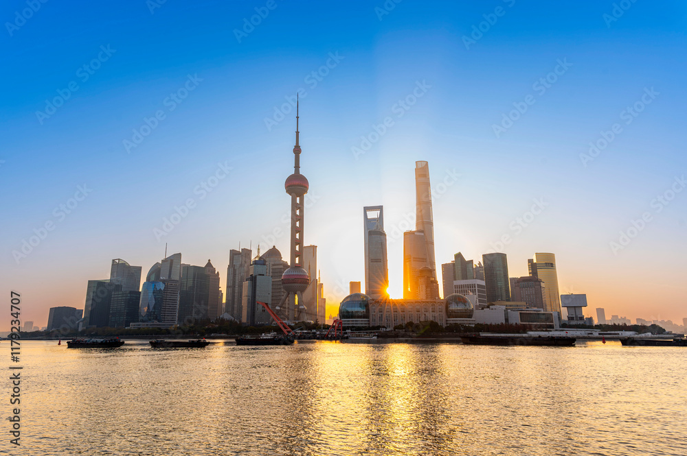 Morning sun rise of Shanghai city modern skyscraper cityscape in blue sky autumn season behind pollution haze, view from the bund in Shanghai, China.
