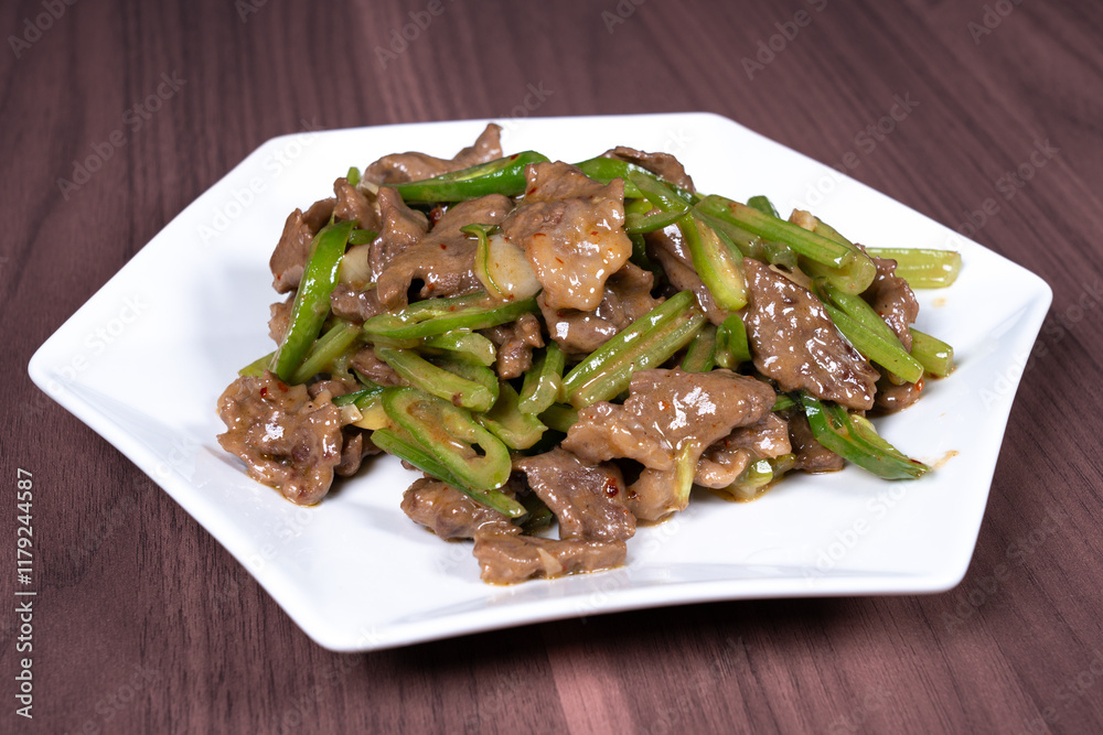 Celery stir-fried beef on a white plate Celery stir-fried beef on a white plate
