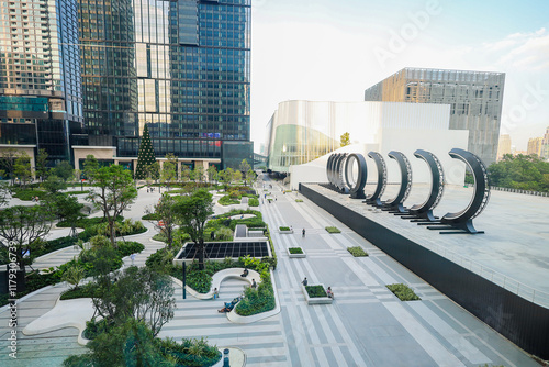 New shopping mall named One Bangkok of Thailand with offices and hotels. There is a large park in the middle and tall buildings surrounding it. photo