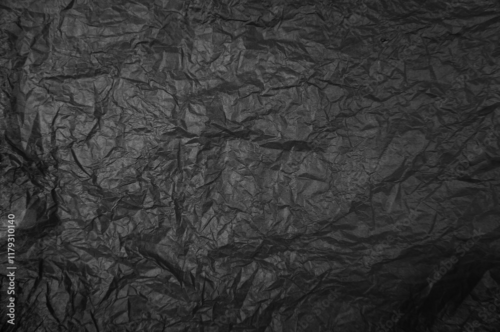 Fototapeta premium Plastikfolie in schwarz als zerknitterter Hintergrund