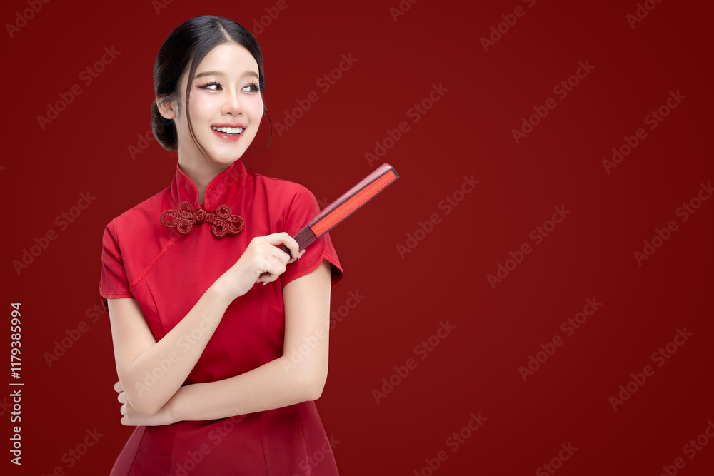 Portrait of joyful beauty Asian woman in red Cheongsam Chinese traditional dress holding red fan isolated on red background. Portrait of joyful beauty Asian woman in red Cheongsam Chinese traditional dress holding red fan isolated on red background.