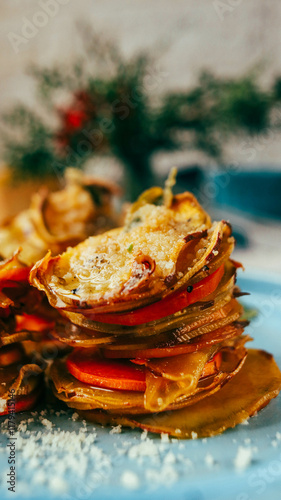 sweet potato baked with cheese appetizing on a plate close-up