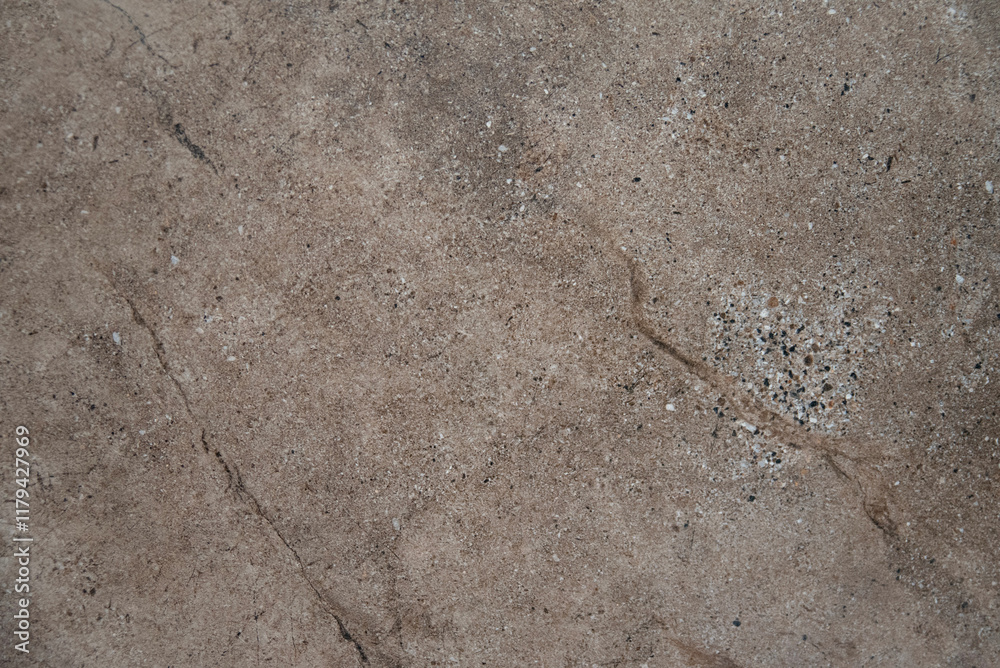 Fototapeta premium Rough beige stone surface with fine specks and natural cracks..