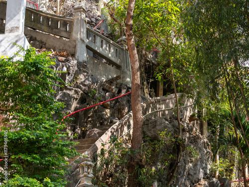 Stairs leading up to the Thai temple on the mountaintop. Wat Phra Phutthabat Pha Nam, Li District, Lamphun Province. photo