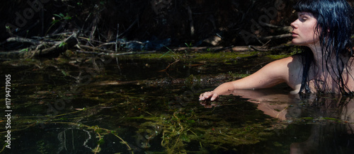 beautiful young sexy nude brunette wet woman mermaid nymph sensual sensitive seductive in green natural water photo