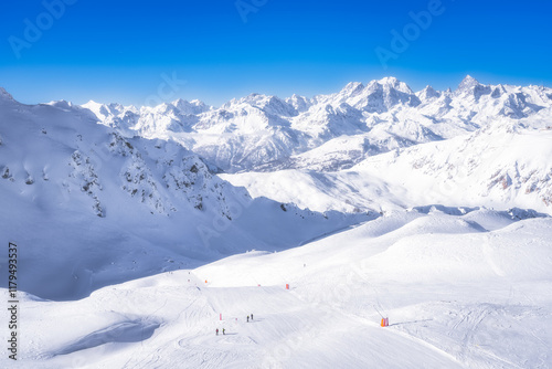 A stunning winter scene with majestic snowcovered mountains under clear blue sky, ideal for winter sports, making it a perfect destination for outdoor adventurers, Montgenevre ski village Alps, France