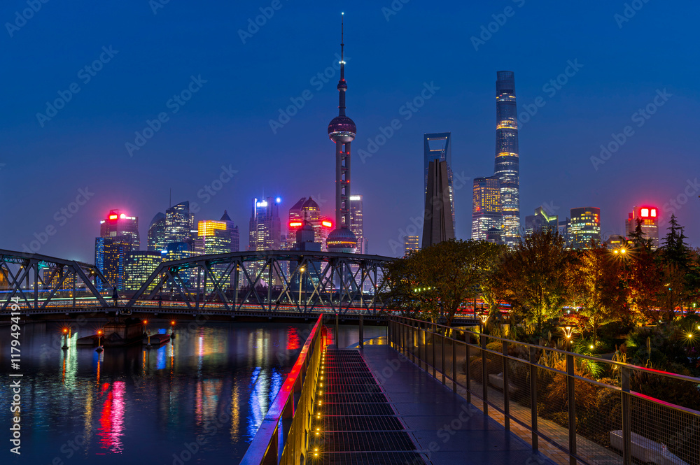 Sunset of Shanghai city modern skyscraper night light cityscape in twilight blue sky in autumn season behind pollution haze, view from the bund in Shanghai, China.