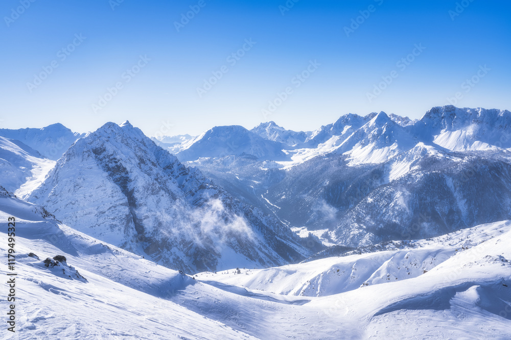 Obraz premium An absolutely breathtaking view of magnificent snowcapped mountain range, perfectly set against a pristine clear blue sky, vividly showcasing the beauty of winter landscapes, Montgenevre, Alps, France