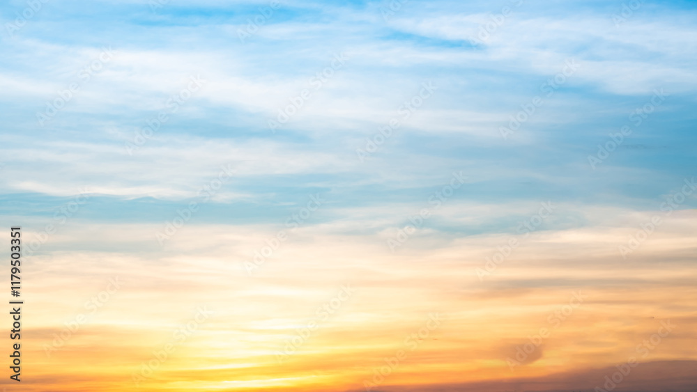 Obraz premium Sky,sunset, beautiful , luxury soft gradient orange gold clouds and sunlight on the blue sky perfect for the background, Sunrise on morning or everning in winter warm time ,Twilight summer,silhouette