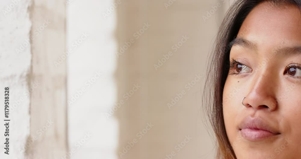 Asian young woman with nose ring gazing thoughtfully, copy space, at home Asian young woman with nose ring gazing thoughtfully, copy space, at home