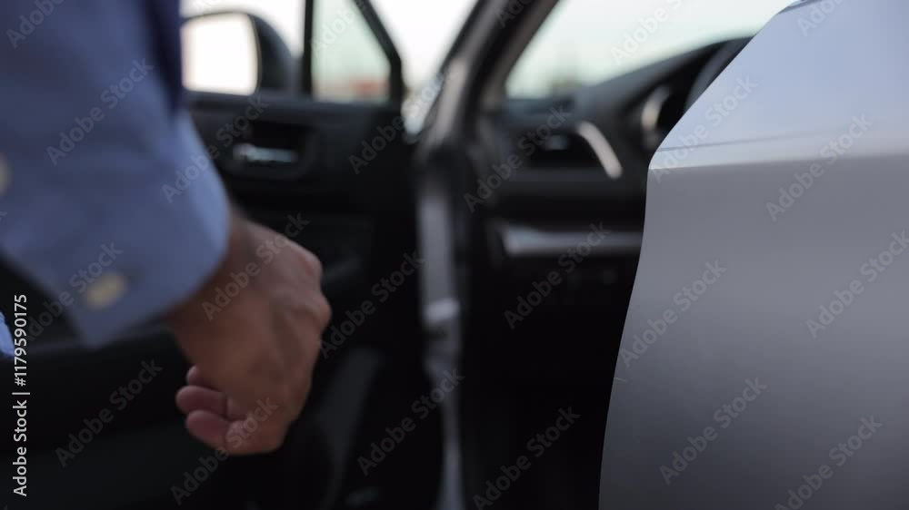Anonymous man driver in casual wear, holding door handle, getting into car outdoors. Close up of male hand with wrist watch opening car door, ready to go. Concept of travel, car rental, business.