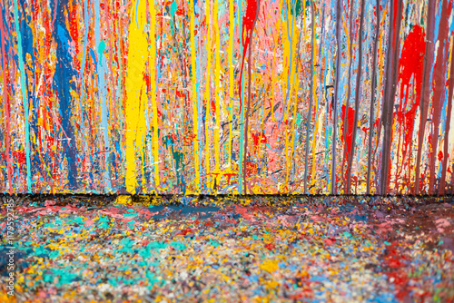 Abstract art features bold paint splatter, drip painting, and vibrant colors on a richly textured floor for modern art, artistic expression, and a creative splash in design or visual projects.