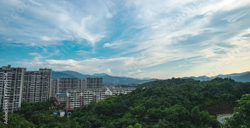 Enjoy breathtaking aerial views of mountains encircling Shaxian City in real time during a tranquil daytime exploration photo