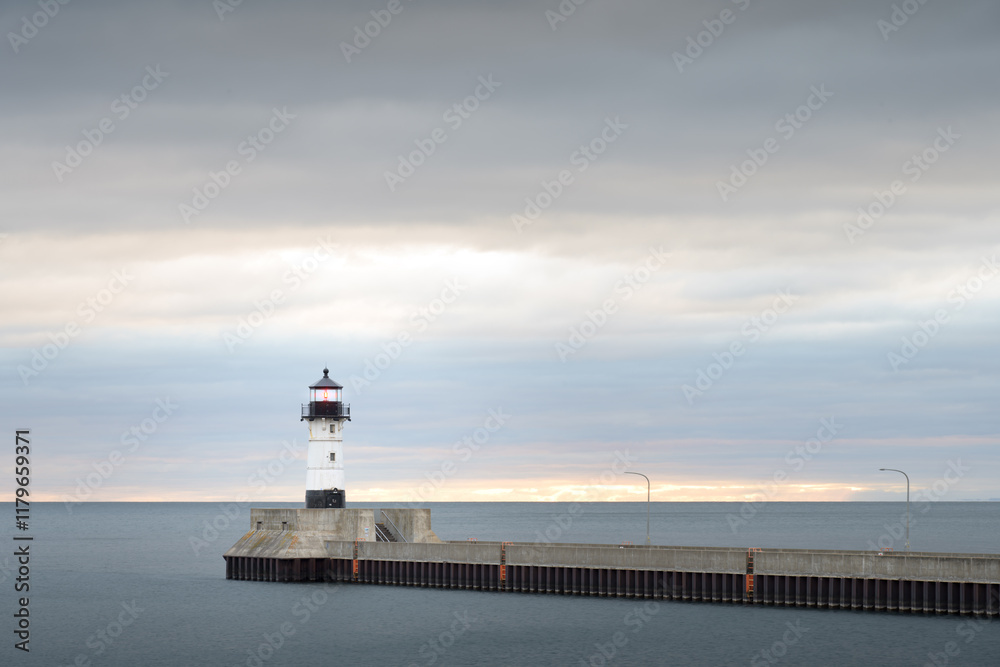 North break wall lighthouse at Duluth Harbor in Minnesota. Early morning with a cloudy sky. Landscape. North break wall lighthouse at Duluth Harbor in Minnesota. Early morning with a cloudy sky. Landscape.