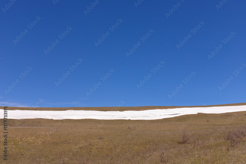 Fototapeta premium Smooth snow and blue sky in the mountains.