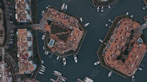 Aerial rotation over mediterranean marina with boats and red roof buildings photo