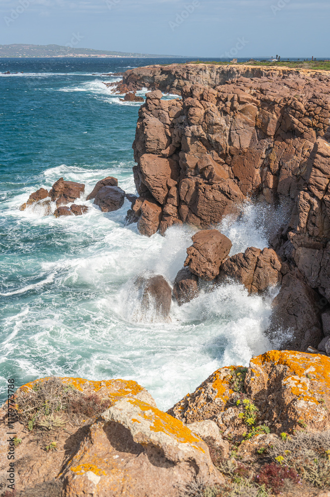 The beautiful high red cliffs of Nido dei Passeri on the island of Sant'Antioco in Sardinia