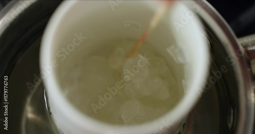 making organic homemade soap, melting base in steam bath, mixes the soap mass, top view