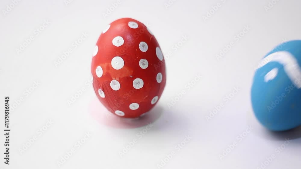 Blue chicken egg with dotted and zigzag pattern hits red egg with polka dots on white table. Concept of dance, battle, rotation, twisting, celebration, holiday. Horizontal video for Happy Easter. Food Blue chicken egg with dotted and zigzag pattern hits red egg with polka dots on white table. Concept of dance, battle, rotation, twisting, celebration, holiday. Horizontal video for Happy Easter. Food