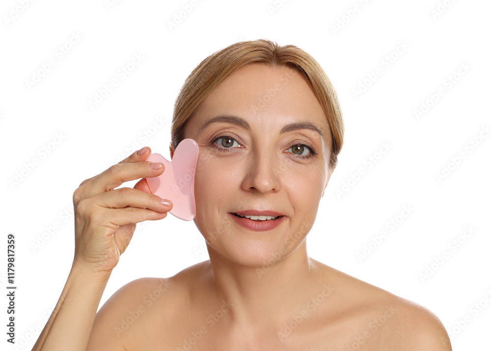 Smiling woman doing facial self massage with gua sha tool on white background Smiling woman doing facial self massage with gua sha tool on white background