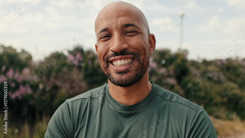 Close-up of strong man, fit guy in sportswear standing outdoors and looking in camera pensively. Motivation and dreams, success in sports, active lifestyle, training and healthy routine