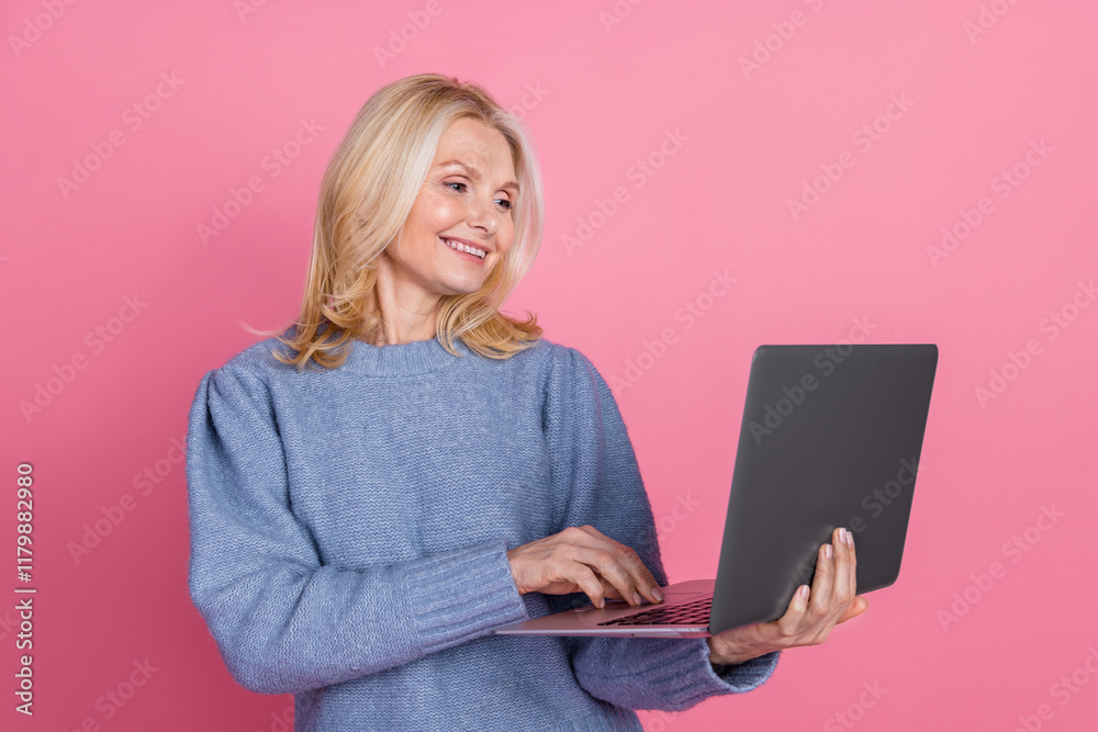 Naklejka premium Photo portrait of lovely pensioner lady hold netbook dressed stylish blue knitted garment isolated on pink color background