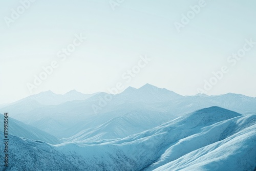 Serene winter landscape showcasing snow-covered mountains under a bright, clear sky.