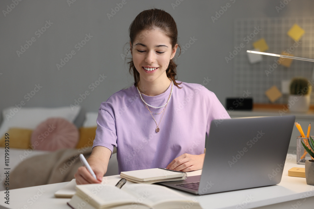 Student preparing for exam at table indoors Student preparing for exam at table indoors