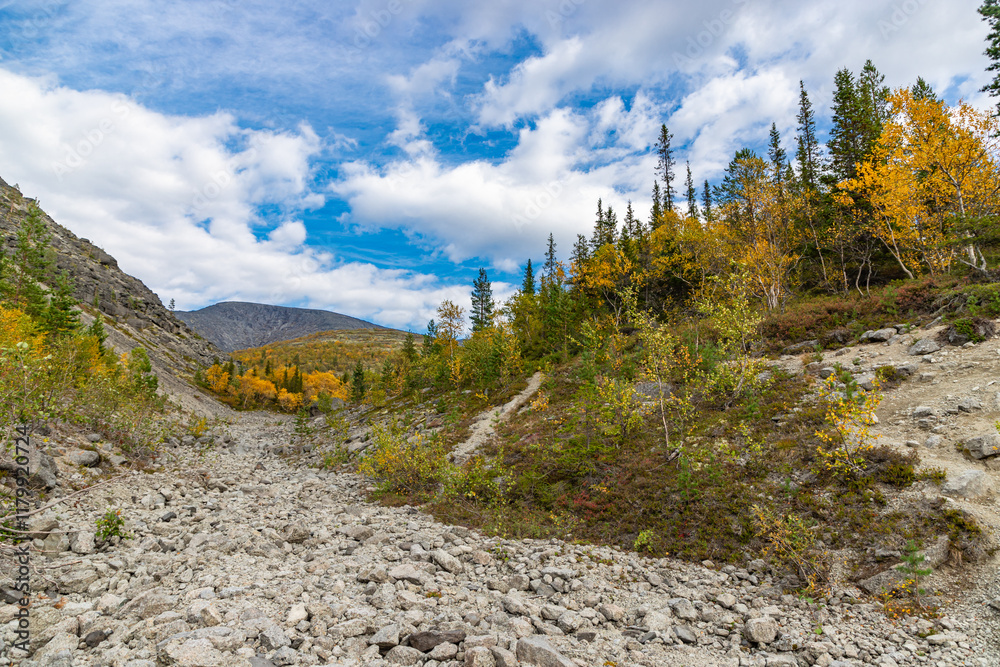 View to Khibiny mountains near Mannepakhp river. Early autumn in arctic tundra region. Kola peninsula, Murmansk region, Russia.