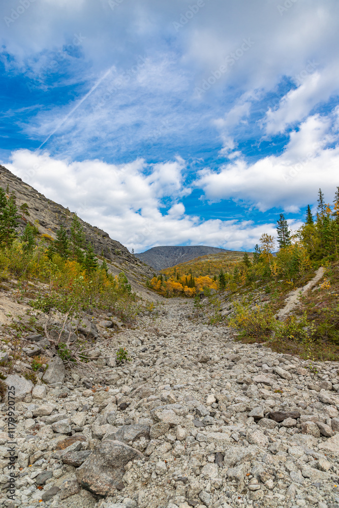 View to Khibiny mountains near Mannepakhp river. Early autumn in arctic tundra region. Kola peninsula, Murmansk region, Russia.