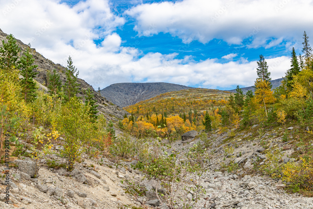 View to Khibiny mountains near Mannepakhp river. Early autumn in arctic tundra region. Kola peninsula, Murmansk region, Russia.