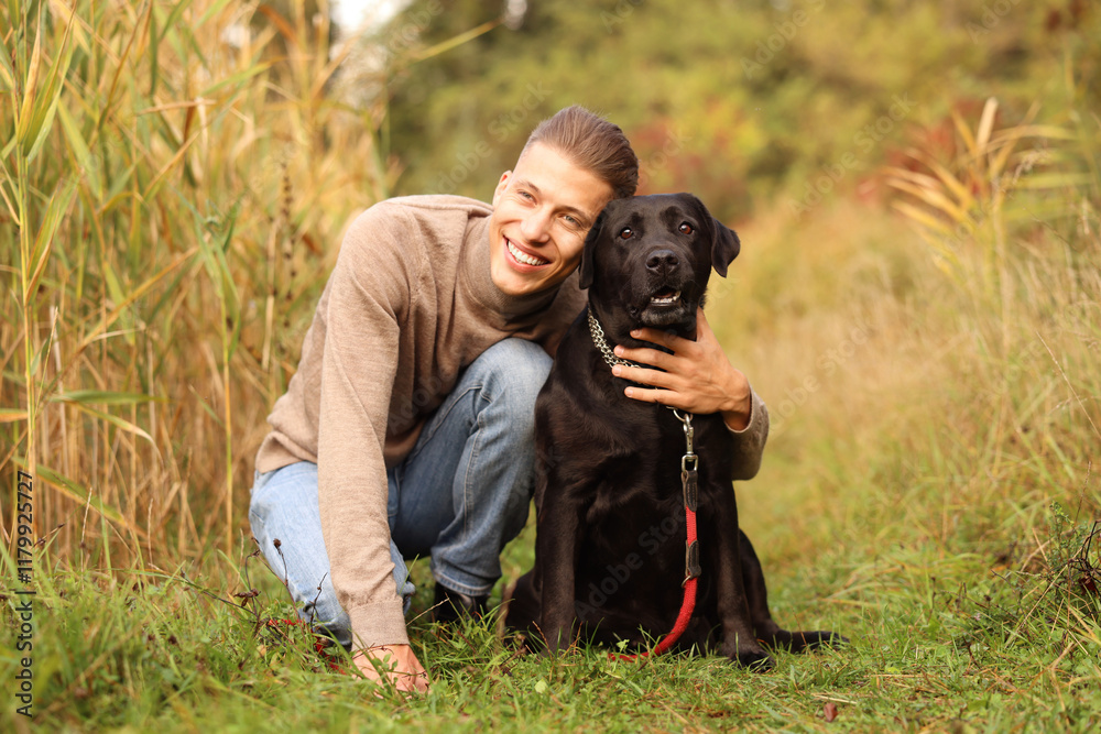 Smiling man with cute dog outdoors on autumn day Smiling man with cute dog outdoors on autumn day