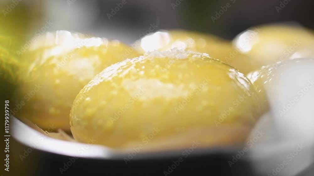 Chef sprinkles bread rolls with sea salt flakes before baking. Slow motion.
Chef sprinkles bread rolls with sea salt flakes before baking. Slow motion.
