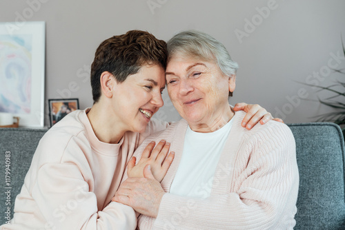 Foto Neutral gender woman hugging her senior mom or grandma, sharing a tender moment together